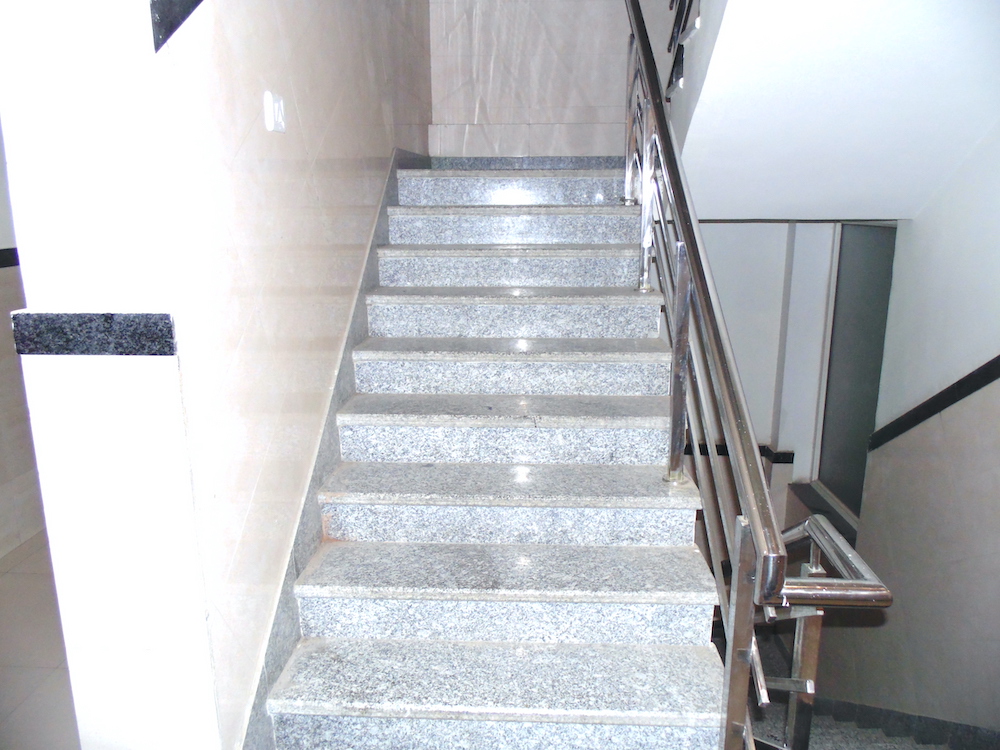 clean staircase with steel railing